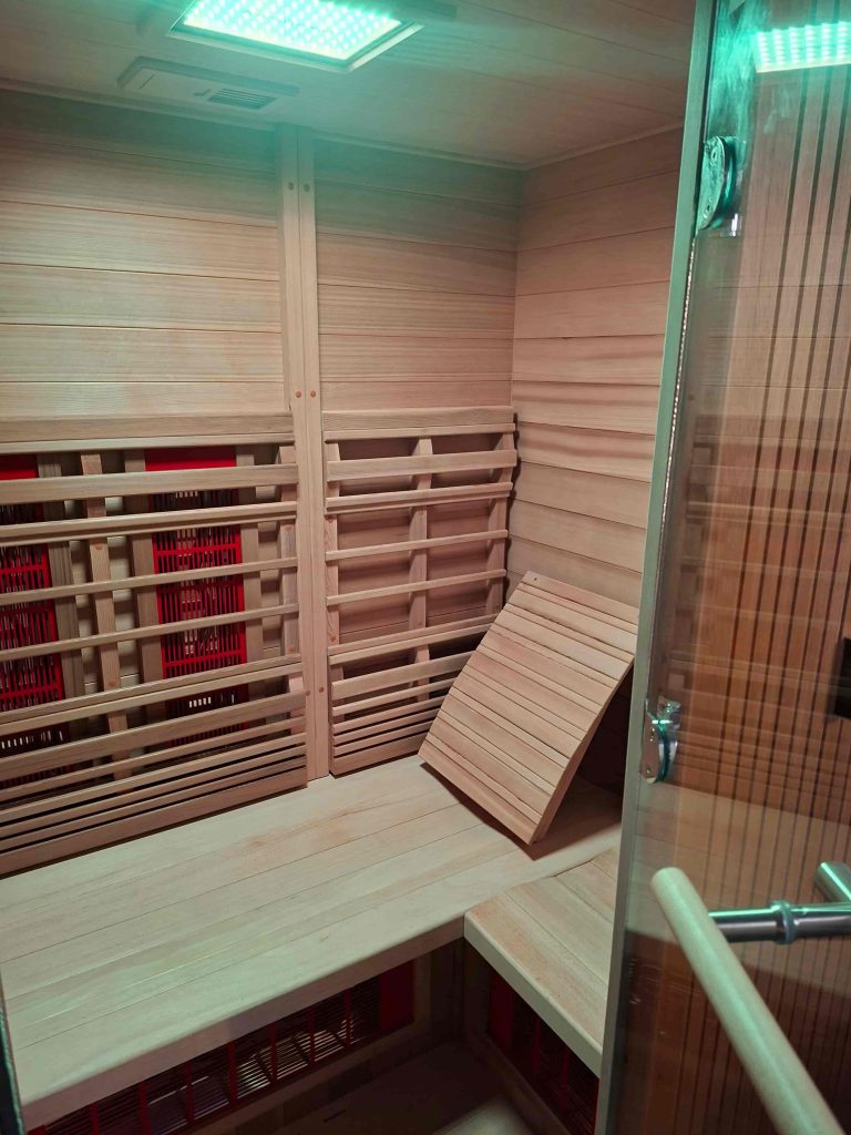 Interieur van infraroodsauna met infraroodpanelen en houten zitbank